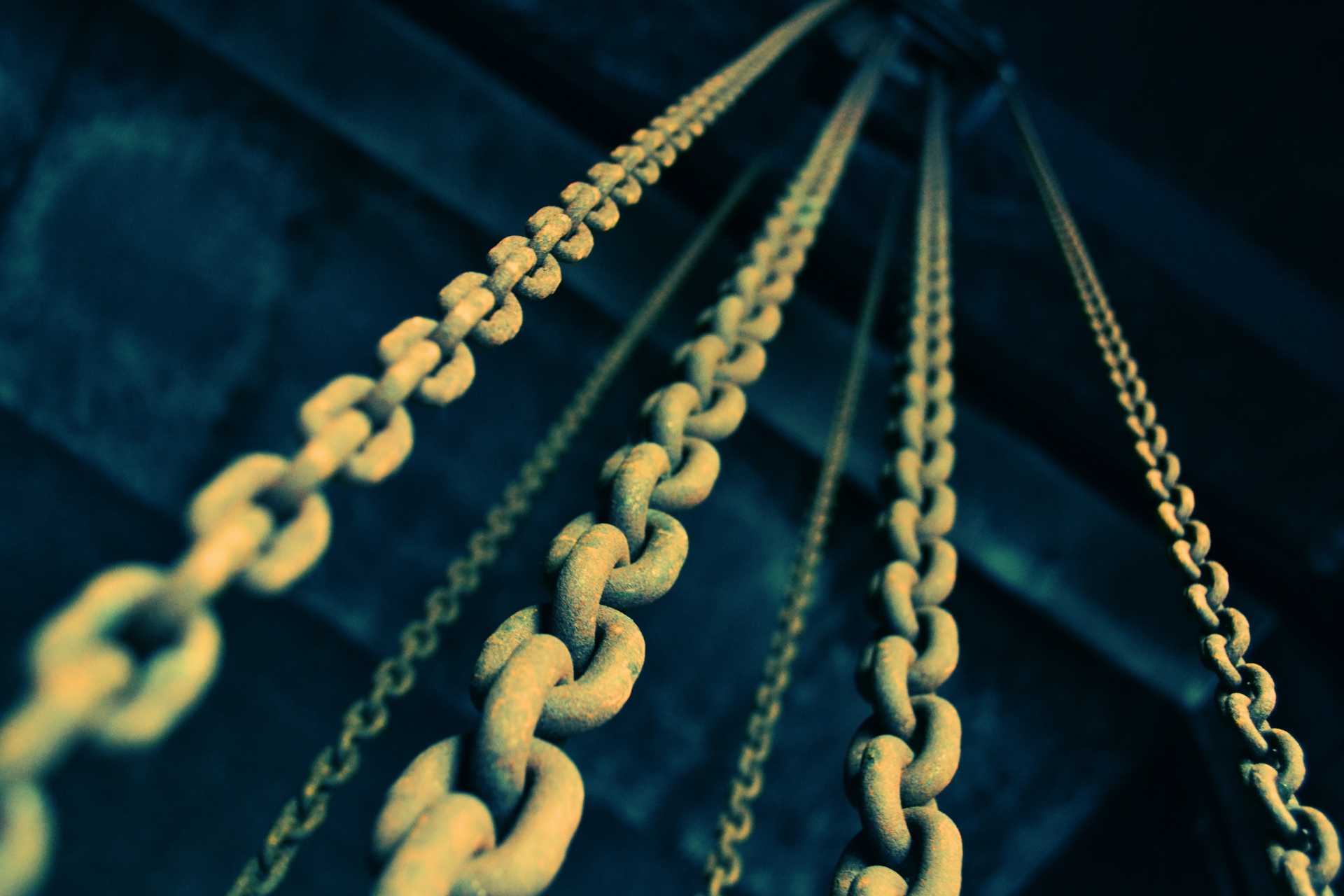 Yellow chains overlaying a dark blue-green background.