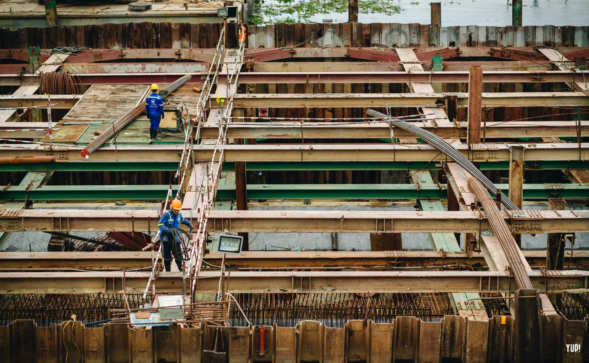 Construction workers in the midst of building a building