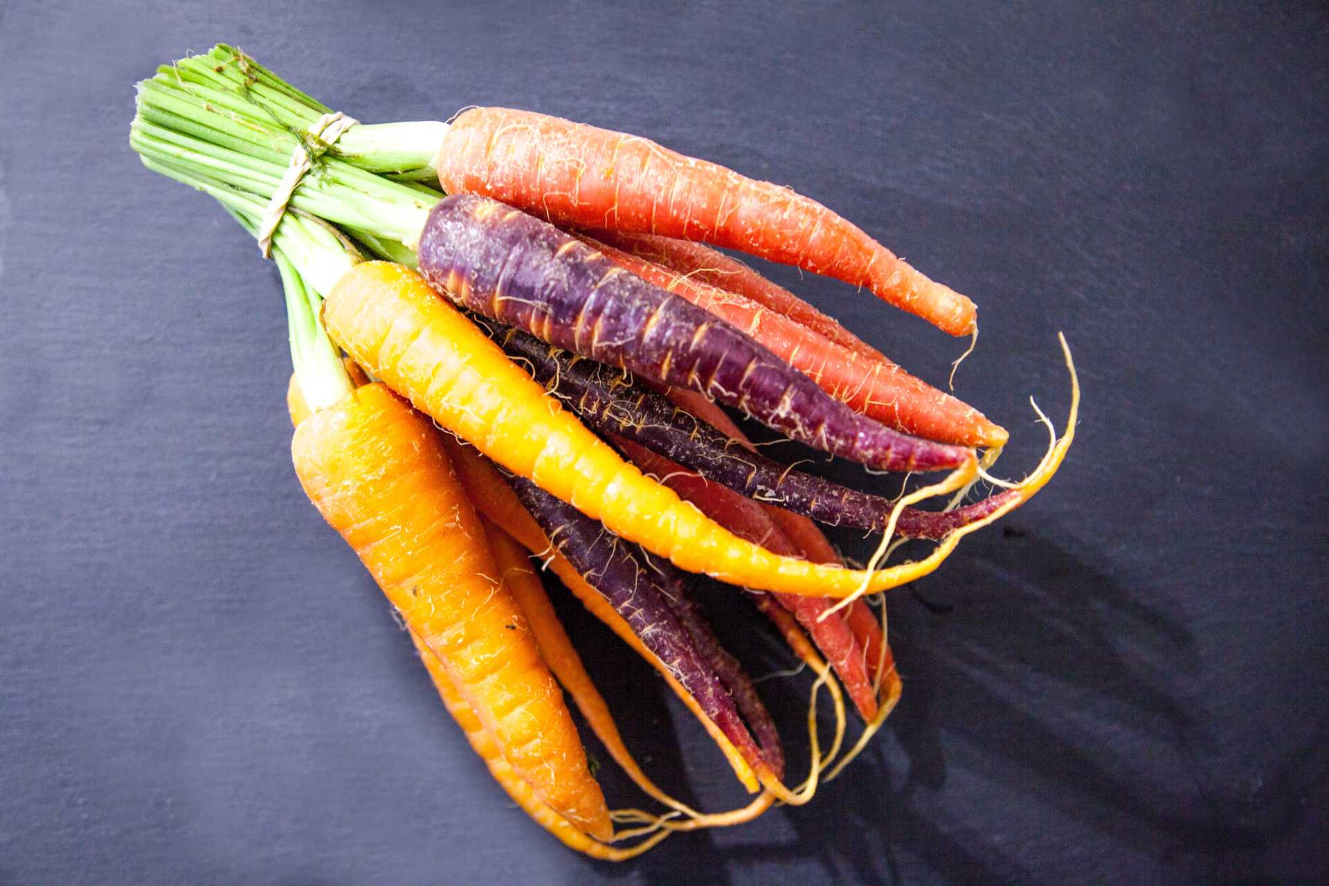 A bundle of carrots. Orange, yellow, and most importantly, purple!